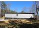 Exterior shot of the home features gray siding and wooden stairs at 7382 Knox Bridge Hwy, Canton, GA 30114