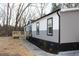 Landscaped yard and modern home with gray and white siding and a sidewalk, a clean, inviting appearance at 7382 Knox Bridge Hwy, Canton, GA 30114