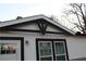 Close-up of the exterior shows white siding, black trim, and decorative gable accent at 7382 Knox Bridge Hwy, Canton, GA 30114