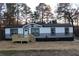 Attractive single-story house showcasing a well-maintained yard, front porch, and gray and white siding at 7382 Knox Bridge Hwy, Canton, GA 30114