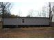 Side view of the home with gray siding, complemented by the surrounding trees at 7382 Knox Bridge Hwy, Canton, GA 30114