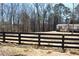 Lovely home with a new porch and a decorative fence in front of a serene tree line at 7382 Knox Bridge Hwy, Canton, GA 30114