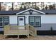 Attractive front entrance with a new wooden deck and stairs at 7382 Knox Bridge Hwy, Canton, GA 30114