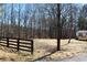 A house on a lot with a wooden fence and a gravel road at 7382 Knox Bridge Hwy, Canton, GA 30114