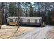 Attractive two-tone home featuring a cozy wooden deck and gravel driveway at 7382 Knox Bridge Hwy, Canton, GA 30114