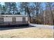 Attractive home with landscaped grounds and gravel driveway at 7382 Knox Bridge Hwy, Canton, GA 30114