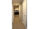 Hallway with gray walls and gray vinyl flooring leading to a modern white kitchen at 7382 Knox Bridge Hwy, Canton, GA 30114