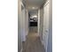 Hallway with gray walls and wood-look vinyl plank flooring leads to the kitchen at 7382 Knox Bridge Hwy, Canton, GA 30114