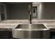 Close up of a modern stainless sink and faucet in a gray kitchen island at 7382 Knox Bridge Hwy, Canton, GA 30114