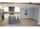 Open-concept kitchen featuring a large island, stainless steel appliances, and modern gray cabinets at 7382 Knox Bridge Hwy, Canton, GA 30114