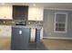 Spacious kitchen with a gray island and modern appliances, complementing white and gray cabinetry at 7382 Knox Bridge Hwy, Canton, GA 30114