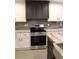 Well-equipped kitchen with stainless steel oven and a stylish tile backsplash at 7382 Knox Bridge Hwy, Canton, GA 30114