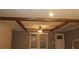 Living room with rustic wood beam ceiling detail and window with blinds at 7382 Knox Bridge Hwy, Canton, GA 30114