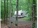 White RV in a forested campground at 7382 Knox Bridge Hwy, Canton, GA 30114