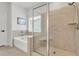 Elegant bathroom showcasing tub, glass-enclosed shower, tiled walls, and modern fixtures at 7438 Jennadee Dr, Fairburn, GA 30213