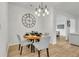 Dining area featuring a modern light fixture and four chairs at 7438 Jennadee Dr, Fairburn, GA 30213