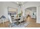 Elegant dining room with modern light fixture and views into the living room at 7438 Jennadee Dr, Fairburn, GA 30213