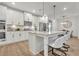 Spacious kitchen with island, bar seating, stainless steel appliances, and stylish pendant lighting at 7438 Jennadee Dr, Fairburn, GA 30213