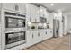 Modern kitchen featuring stainless steel appliances, double wall oven and a tile backsplash at 7438 Jennadee Dr, Fairburn, GA 30213