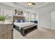 Bright main bedroom features tray ceilings, windows, and a neutral color palette at 7438 Jennadee Dr, Fairburn, GA 30213