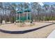 Community playground with slides, swings, and soft mulch ground cover at 7438 Jennadee Dr, Fairburn, GA 30213