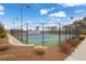 The community tennis court is surrounded by a fence, trees and greenery at 7438 Jennadee Dr, Fairburn, GA 30213