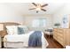Bedroom features ceiling fan, hardwood floors, a light wood dresser and woven headboard at 100 Biscayne Nw Dr # 4, Atlanta, GA 30309