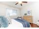 Bedroom features ceiling fan, hardwood floors, a light wood dresser and woven headboard at 100 Biscayne Nw Dr # 4, Atlanta, GA 30309