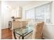 Light-filled dining area with woven chairs and a glass table adjacent to the kitchen at 100 Biscayne Nw Dr # 4, Atlanta, GA 30309
