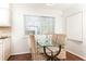 Cozy dining area with woven chairs and a glass table near a window at 100 Biscayne Nw Dr # 4, Atlanta, GA 30309