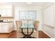 Bright dining area with woven chairs and a glass table next to the kitchen at 100 Biscayne Nw Dr # 4, Atlanta, GA 30309