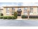 Charming brick apartment building featuring well-manicured landscaping and a covered entryway at 100 Biscayne Nw Dr # 4, Atlanta, GA 30309