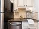 A kitchen featuring granite counters, tile backsplash, and stainless-steel appliances at 100 Biscayne Nw Dr # 4, Atlanta, GA 30309