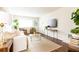 Bright living room with a white sofa, brown leather chairs and a glass coffee table at 100 Biscayne Nw Dr # 4, Atlanta, GA 30309