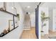 Bright hallway featuring light wood floors, decorative shelving, and a stylish barn door at 220 Village Overlook # K2, Canton, GA 30114