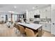 Open-concept kitchen boasts a large island, white cabinets, and seamless flow to the living area at 220 Village Overlook # K2, Canton, GA 30114