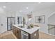Bright kitchen featuring an island with a sink, stainless steel appliances, and white countertops at 220 Village Overlook # K2, Canton, GA 30114
