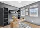 This home office features custom built-ins, a sleek desk, and lots of natural light at 220 Village Overlook # K2, Canton, GA 30114