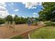 Community playground with swings, slide, and climbing area, surrounded by trees and lawn at 220 Village Overlook # K2, Canton, GA 30114