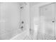 Well-lit bathroom features a shower, subway tiles, and patterned floors at 437 Westmeath Sw Dr, Atlanta, GA 30310