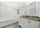 Spacious bathroom with soaking tub, granite countertops, and updated fixtures provides comfort at 437 Westmeath Sw Dr, Atlanta, GA 30310