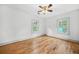 Empty bedroom with hardwood floors, ceiling fan, and two windows providing plenty of natural light at 437 Westmeath Sw Dr, Atlanta, GA 30310