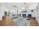 Open-concept living room with fireplace, hardwood floors, and seamless flow to the kitchen and dining areas at 437 Westmeath Sw Dr, Atlanta, GA 30310