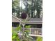 A vibrant red sunflower stands tall in the garden, with the home's porch visible, creating a tranquil, garden-to-home connection at 437 Westmeath Sw Dr, Atlanta, GA 30310