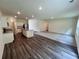 Open-concept kitchen flowing into a carpeted living space with recessed lighting at 7717 Sudbury Cir, Covington, GA 30014