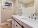 Bathroom featuring double sink vanity with sliding barn door accents and a bright mirror at 3119 Windfield Cir, Tucker, GA 30084