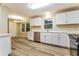 Well-lit kitchen featuring white cabinets, quartz countertops and stainless steel dishwasher at 3119 Windfield Cir, Tucker, GA 30084
