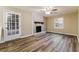 Bright living area with rustic fireplace, ceiling fan, and door to the backyard at 3119 Windfield Cir, Tucker, GA 30084