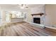 Spacious living room featuring wood-look floors and a whitewashed brick fireplace at 3119 Windfield Cir, Tucker, GA 30084