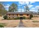 Charming one-story home with a brick and yellow-sided facade and a well-manicured front yard under a cloudy sky at 3354 Wakefield Dr, Decatur, GA 30034